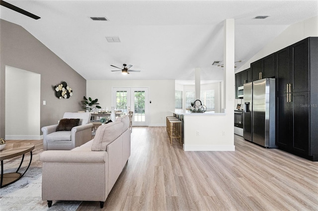 living room featuring french doors, ceiling fan, lofted ceiling, and light hardwood / wood-style flooring