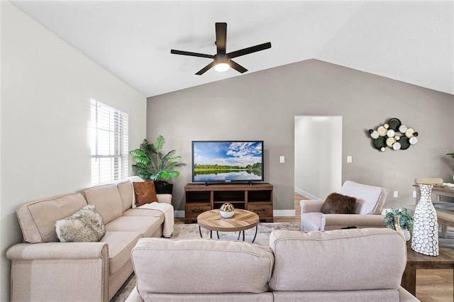 living room featuring vaulted ceiling, wood-type flooring, and ceiling fan