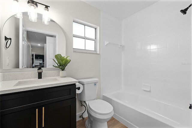 full bathroom with vanity, tub / shower combination, hardwood / wood-style floors, and toilet