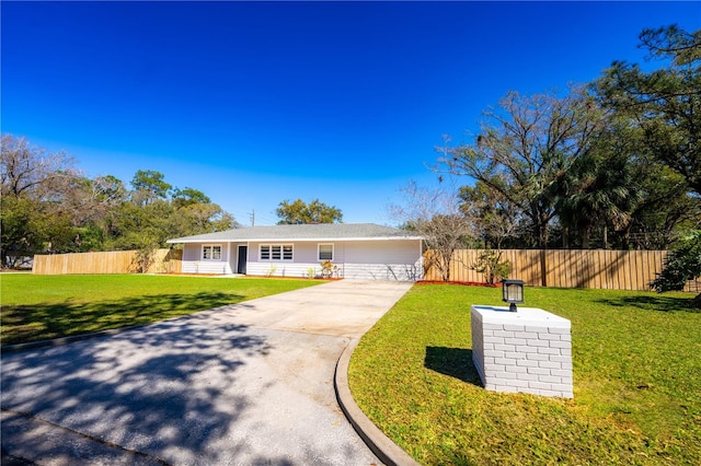 single story home with a front yard and a garage