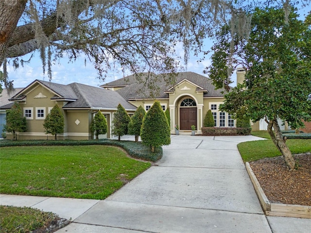 ranch-style home with a front yard