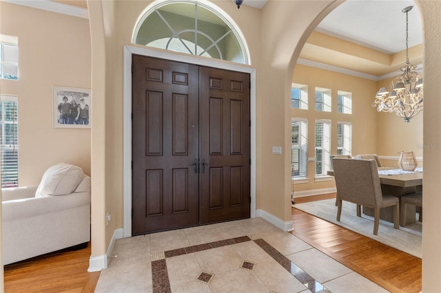 entrance foyer featuring light hardwood / wood-style flooring, plenty of natural light, and a chandelier
