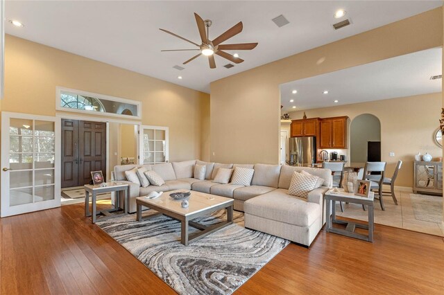 living room with light hardwood / wood-style floors and ceiling fan