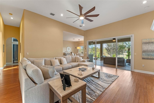living room featuring ceiling fan and wood-type flooring