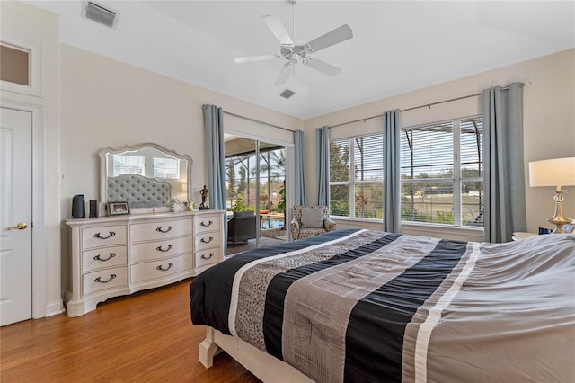 bedroom featuring ceiling fan, light hardwood / wood-style flooring, and access to outside