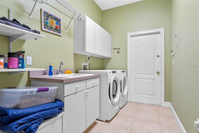 laundry room with cabinets, independent washer and dryer, sink, and light tile patterned floors