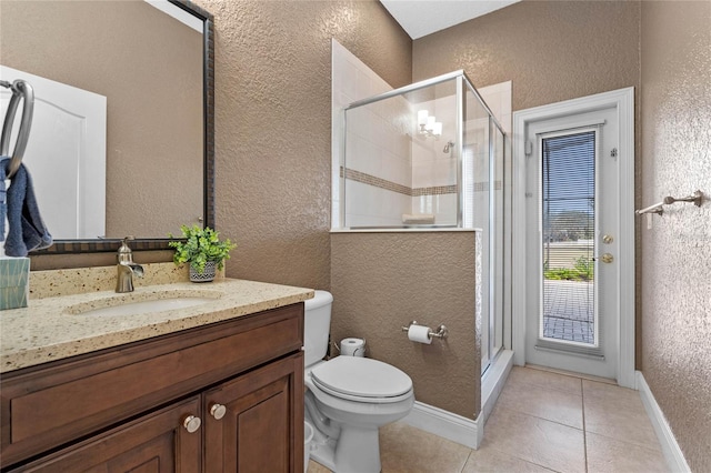 bathroom with vanity, tile patterned floors, toilet, and walk in shower