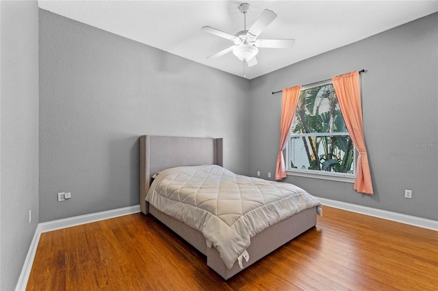 bedroom with hardwood / wood-style flooring and ceiling fan