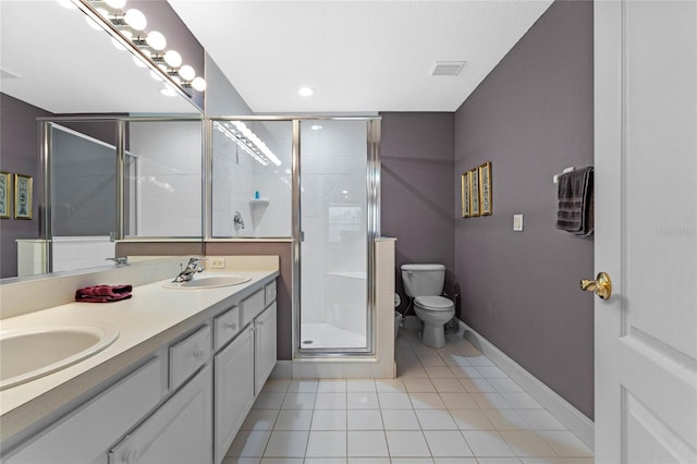 bathroom with vanity, toilet, tile patterned floors, and walk in shower