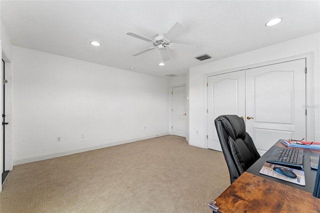 carpeted home office with ceiling fan