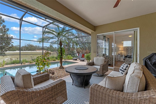 sunroom / solarium featuring ceiling fan
