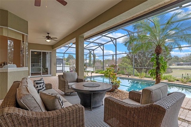 sunroom featuring ceiling fan