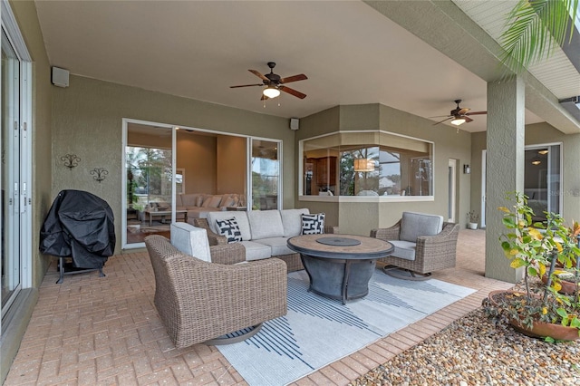 view of patio / terrace featuring area for grilling, an outdoor living space with a fire pit, and ceiling fan