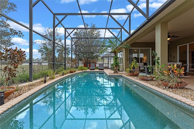 view of pool with a lanai, a patio, and ceiling fan