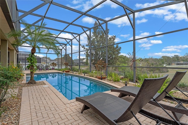 view of swimming pool featuring a lanai and a patio
