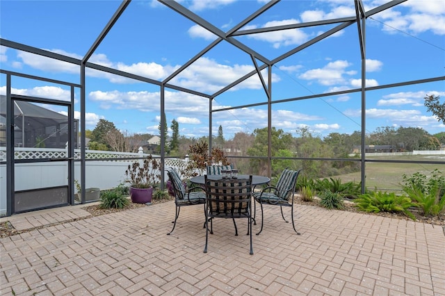 view of patio featuring a lanai