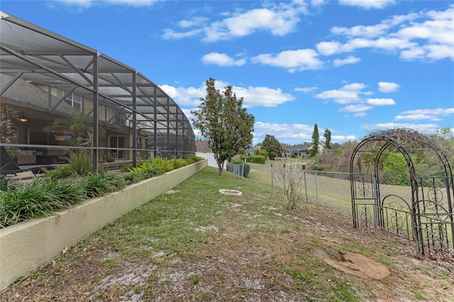view of yard with glass enclosure