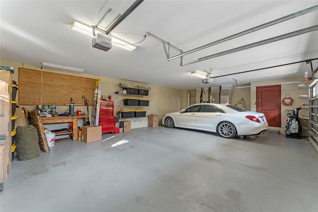 garage featuring a garage door opener and a workshop area
