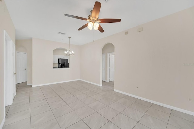 empty room featuring ceiling fan with notable chandelier