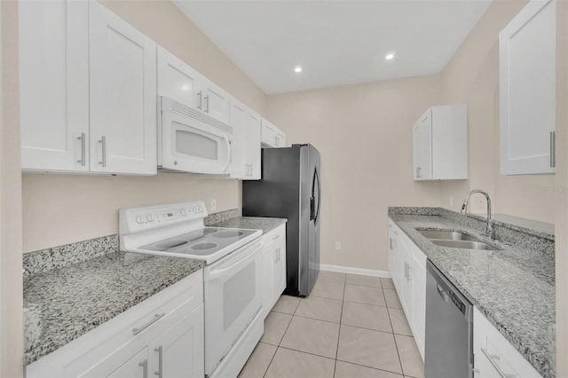 kitchen with sink, white cabinets, light stone countertops, and stainless steel appliances