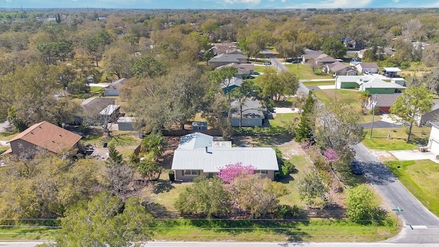 bird's eye view featuring a wooded view and a residential view
