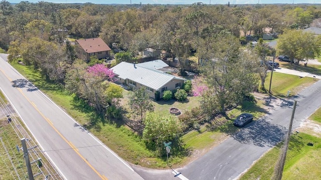 drone / aerial view featuring a forest view
