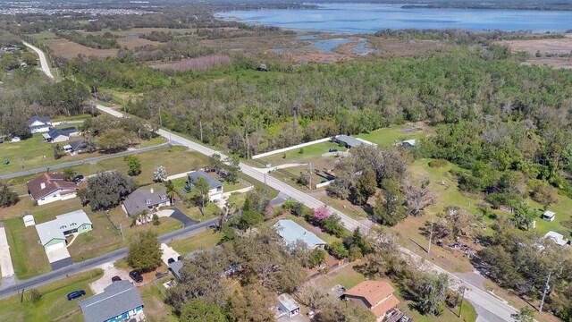 birds eye view of property with a forest view and a water view