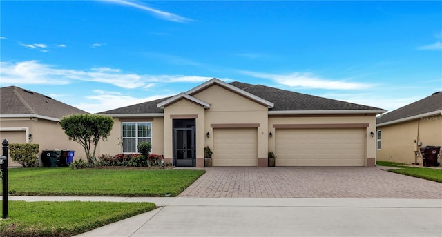 ranch-style home with a garage and a front lawn