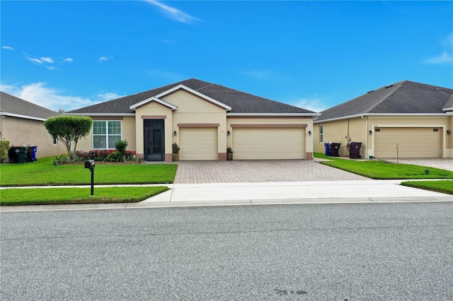 ranch-style home with a garage and a front lawn