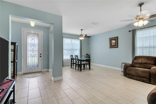 foyer entrance with ceiling fan