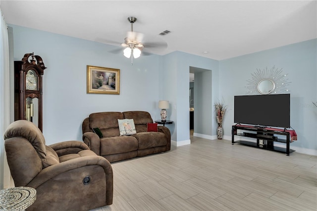 living room featuring ceiling fan and light wood-type flooring