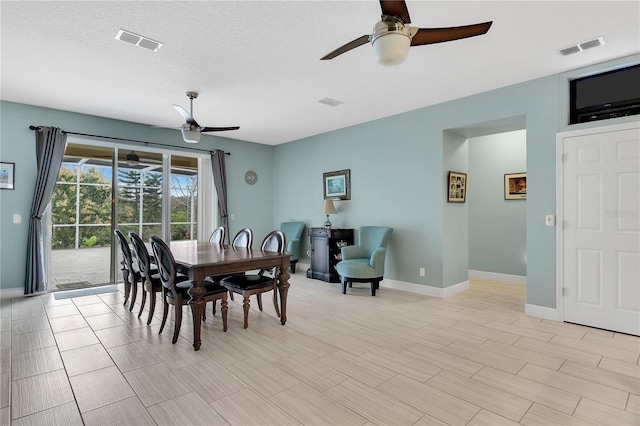 dining area featuring a textured ceiling and ceiling fan