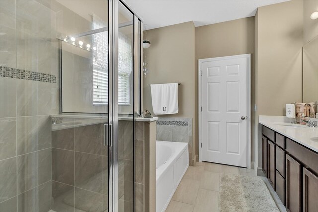 bathroom featuring vanity and independent shower and bath