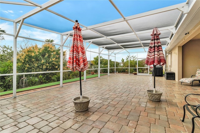 view of patio featuring a lanai