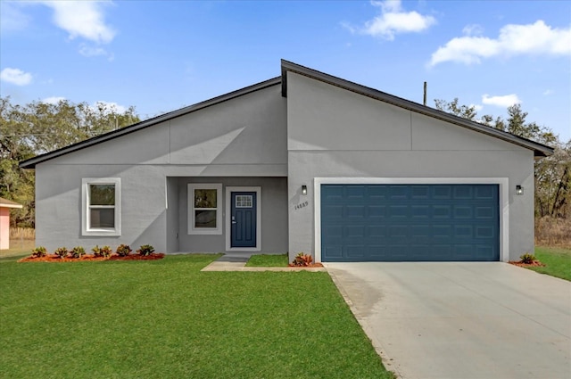 view of front of home with a garage and a front lawn