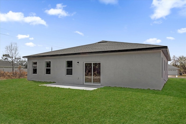 back of house featuring a patio area and a lawn