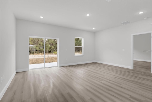 unfurnished room with light wood-type flooring