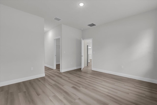 unfurnished room with light wood-type flooring