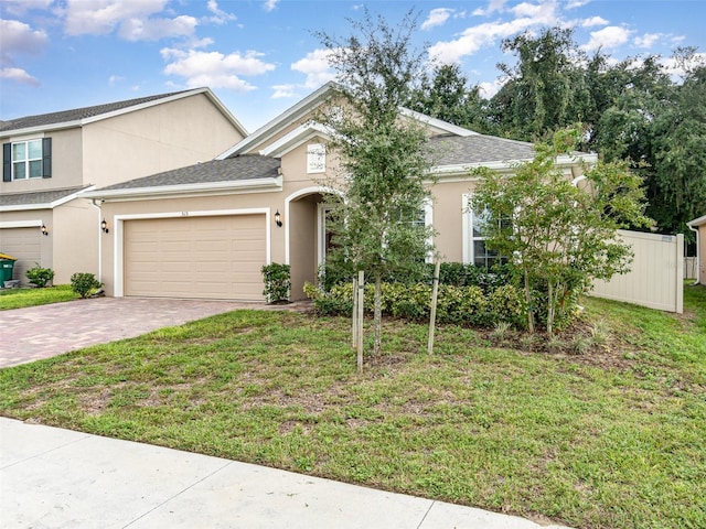 view of front facade featuring a garage and a front lawn