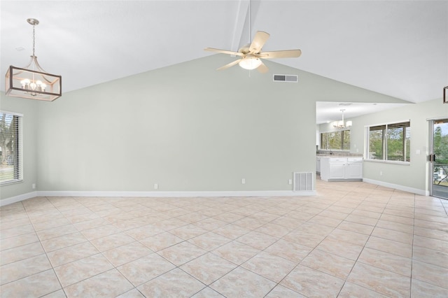 empty room featuring vaulted ceiling with beams, ceiling fan with notable chandelier, and light tile patterned floors