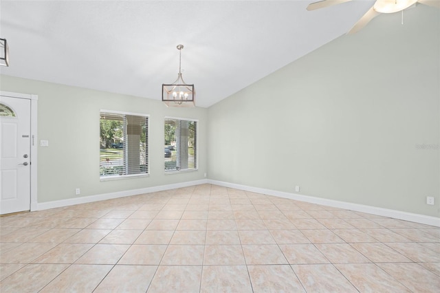 tiled spare room featuring ceiling fan with notable chandelier and vaulted ceiling