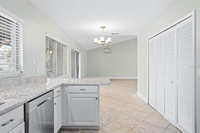 kitchen featuring vaulted ceiling, white cabinetry, hanging light fixtures, stainless steel dishwasher, and an inviting chandelier