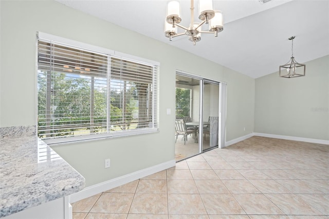 unfurnished dining area with vaulted ceiling, plenty of natural light, light tile patterned floors, and a notable chandelier