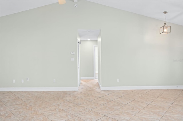 tiled spare room featuring lofted ceiling with beams