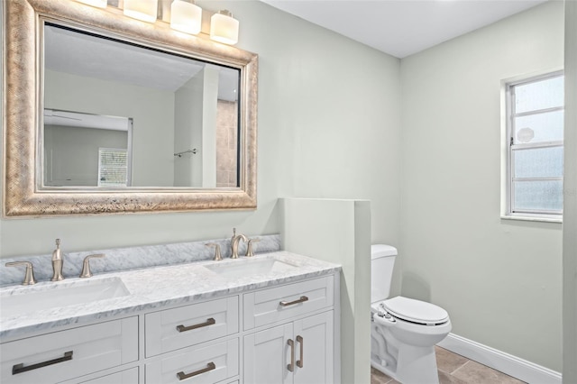 bathroom featuring tile patterned flooring, vanity, and toilet