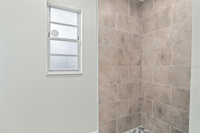 bathroom with a tile shower