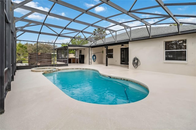 view of swimming pool with an in ground hot tub, a patio, and glass enclosure