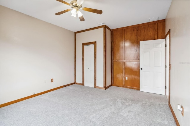 unfurnished bedroom featuring ceiling fan and light colored carpet