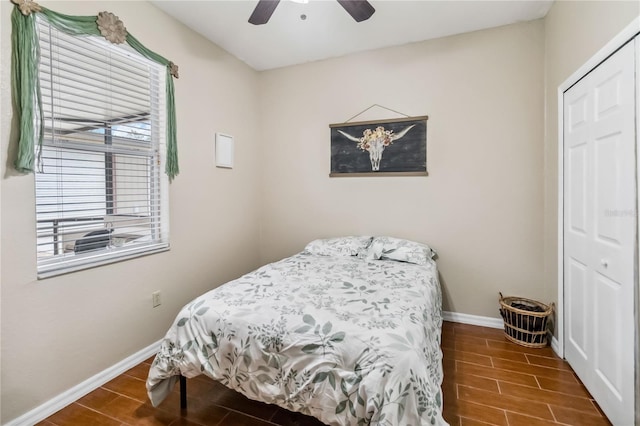 bedroom with ceiling fan and a closet