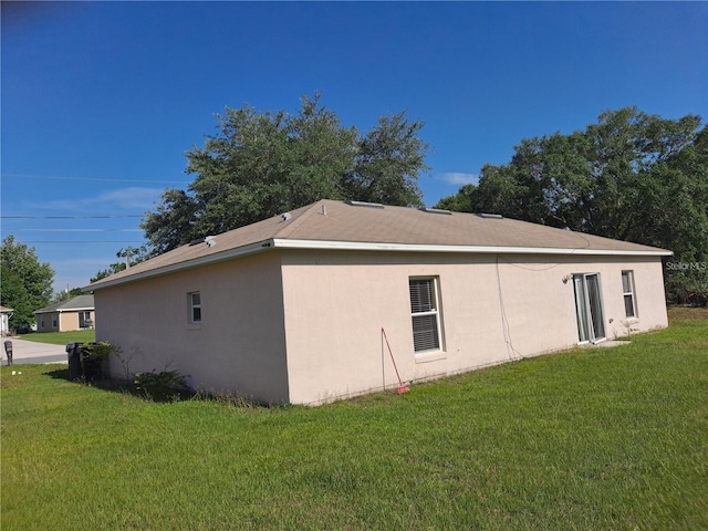 view of side of home featuring a yard